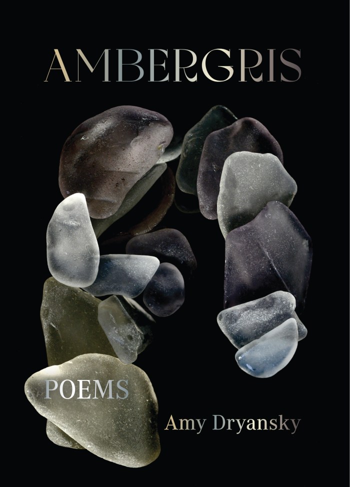 An arc of floating sea glass in ambers and blues on a dark background